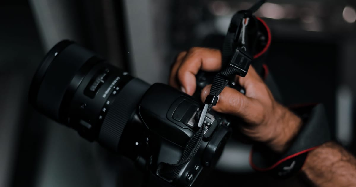 A photographer holding a camera up to shoot
