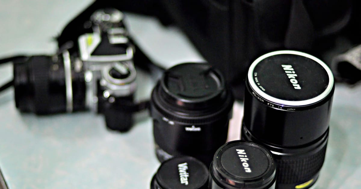 Four zoom lenses standing on a table