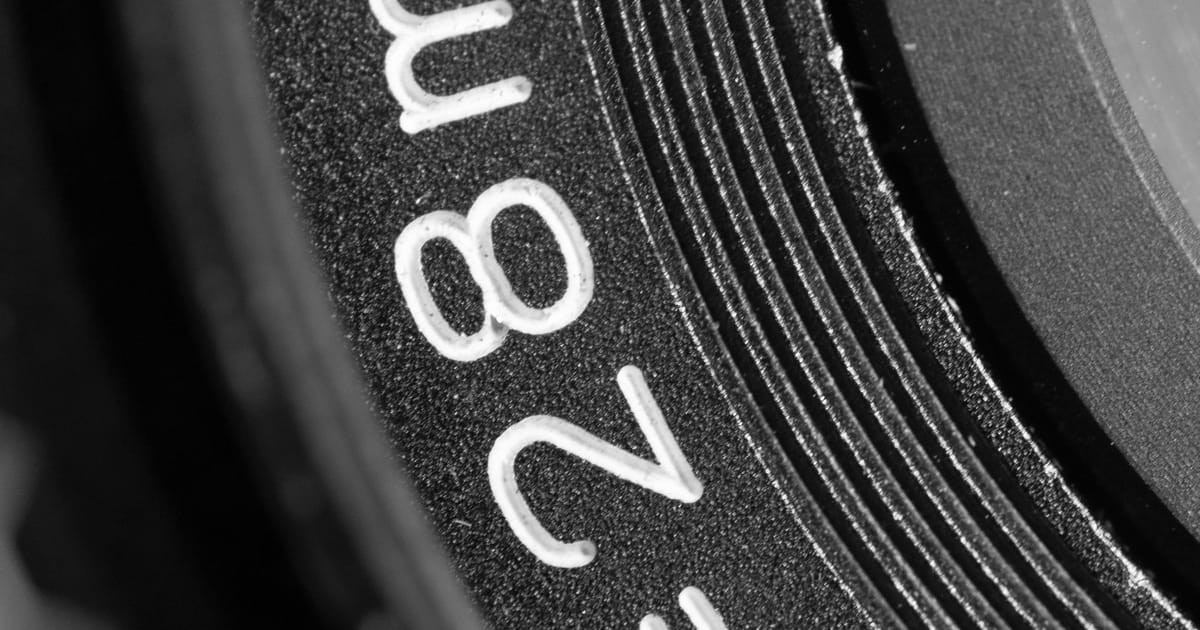 Close-up of a lens barrel showing its focal length marking